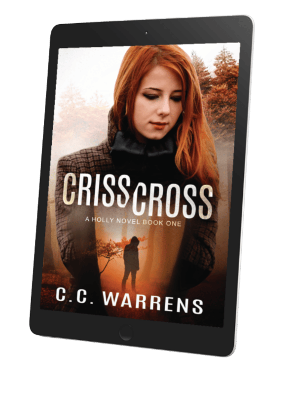 Ebook cover of 'Criss Cross: A Holly Novel Book One' by C.C. Warrens featuring a woman with long reddish hair and a cozy jacket against a blurred autumn background.